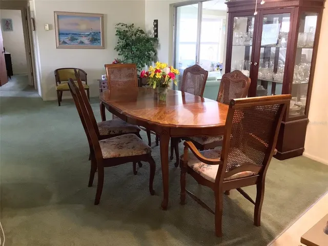 a view of a dining room with furniture and window