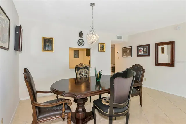 a large bedroom with a bed and a flat tv screen on dresser