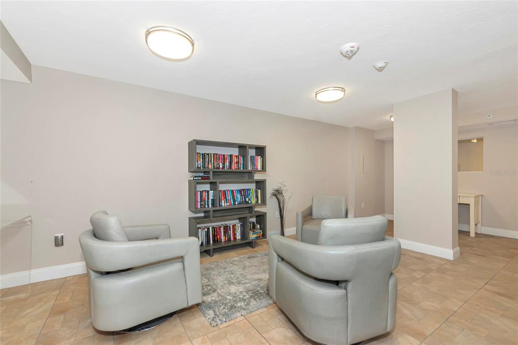 101 South Gulfstream Avenue, Unit 16C Sarasota, FL 34236 - Photo 17 of 86 a living room with furniture and a book shelf