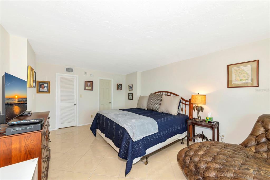 101 South Gulfstream Avenue, Unit 16C Sarasota, FL 34236 - Photo 24 of 86 a bedroom with a bed and a flat screen tv
