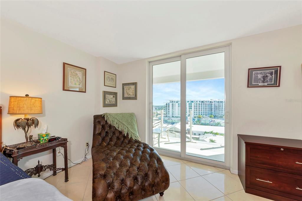 101 South Gulfstream Avenue, Unit 16C Sarasota, FL 34236 - Photo 26 of 86 a bedroom with a bed and wooden floor