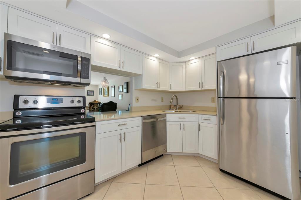 101 South Gulfstream Avenue, Unit 16C Sarasota, FL 34236 - Photo 38 of 86 a kitchen with a refrigerator stove and microwave