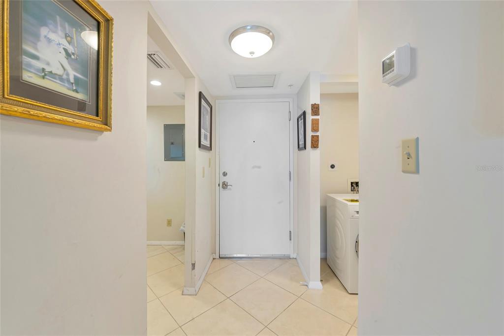 101 South Gulfstream Avenue, Unit 16C Sarasota, FL 34236 - Photo 43 of 86 a view of a hallway with paintings on the wall