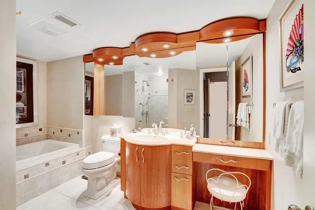a bathroom with a sink a toilet and a mirror