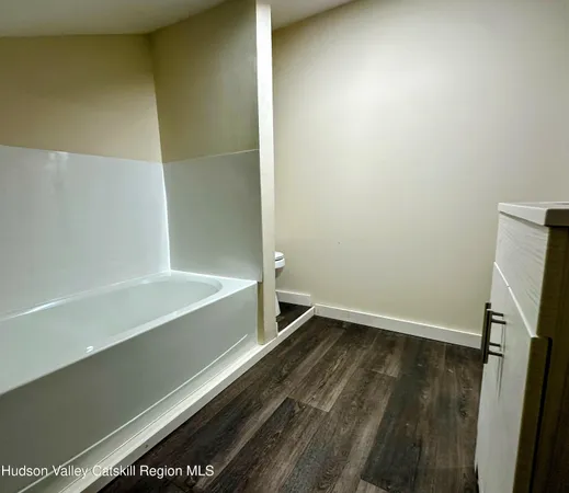 a bathroom with a bathtub and shower