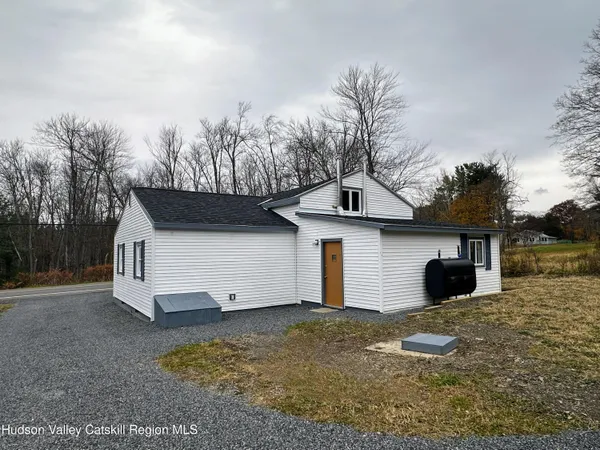 a view of a house with a yard and garage