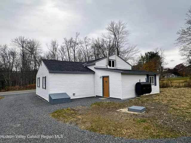 a view of a house with a yard and garage