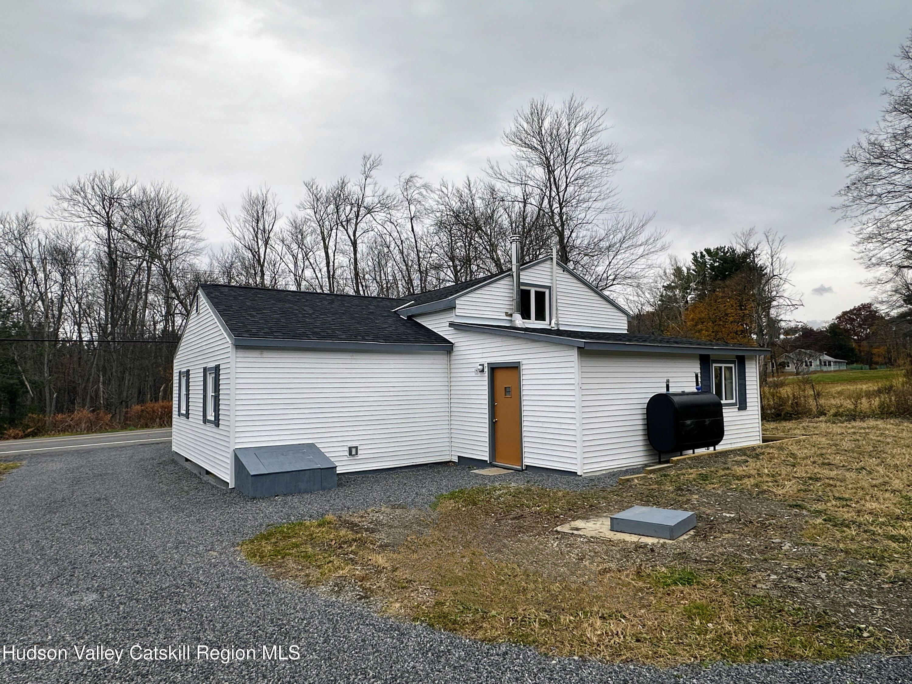 3264 County Route 7 Ancram, NY 12502 - Photo 18 of 19 a view of a house with a yard and garage
