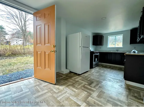 a view of livingroom with workspace and a window