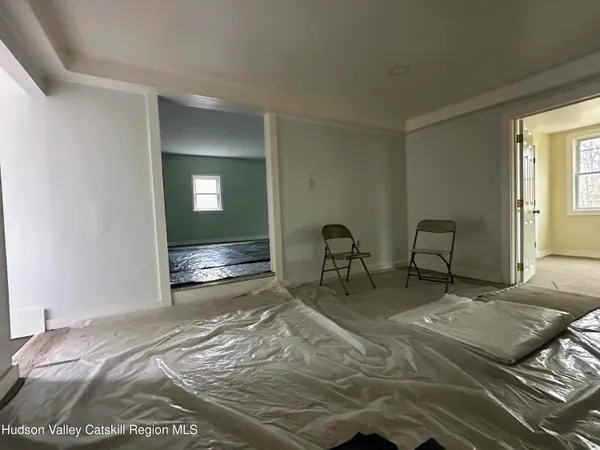 a bed room with a bed and a chair