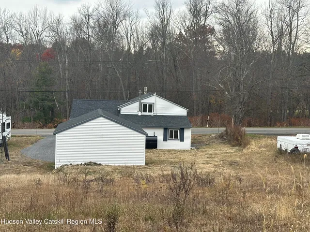 a backyard of a house with table and chairs
