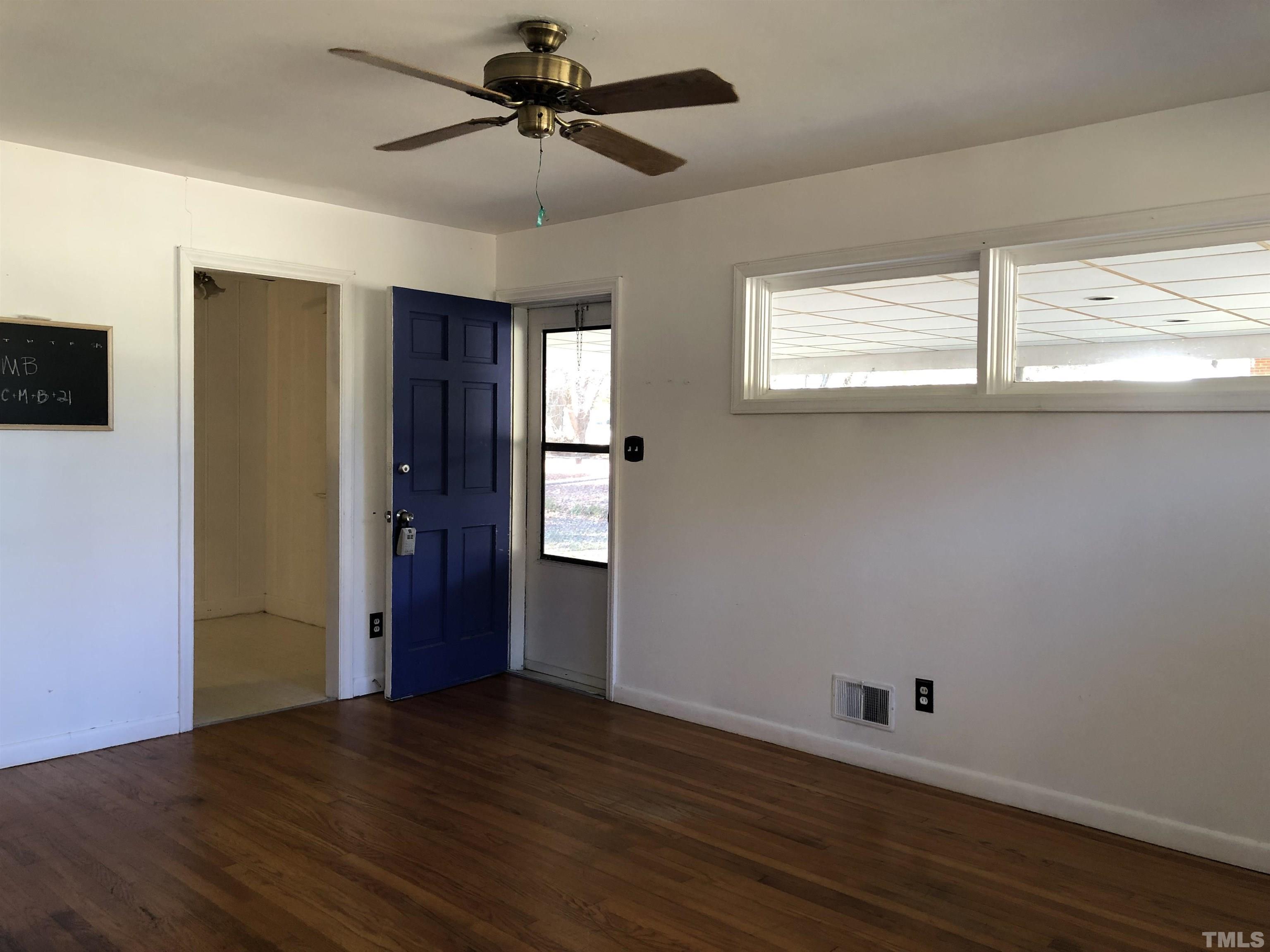 1402 Southerlund Road Garner, NC 27529 - Photo 3 of 18 a view of empty room with wooden floor and fan