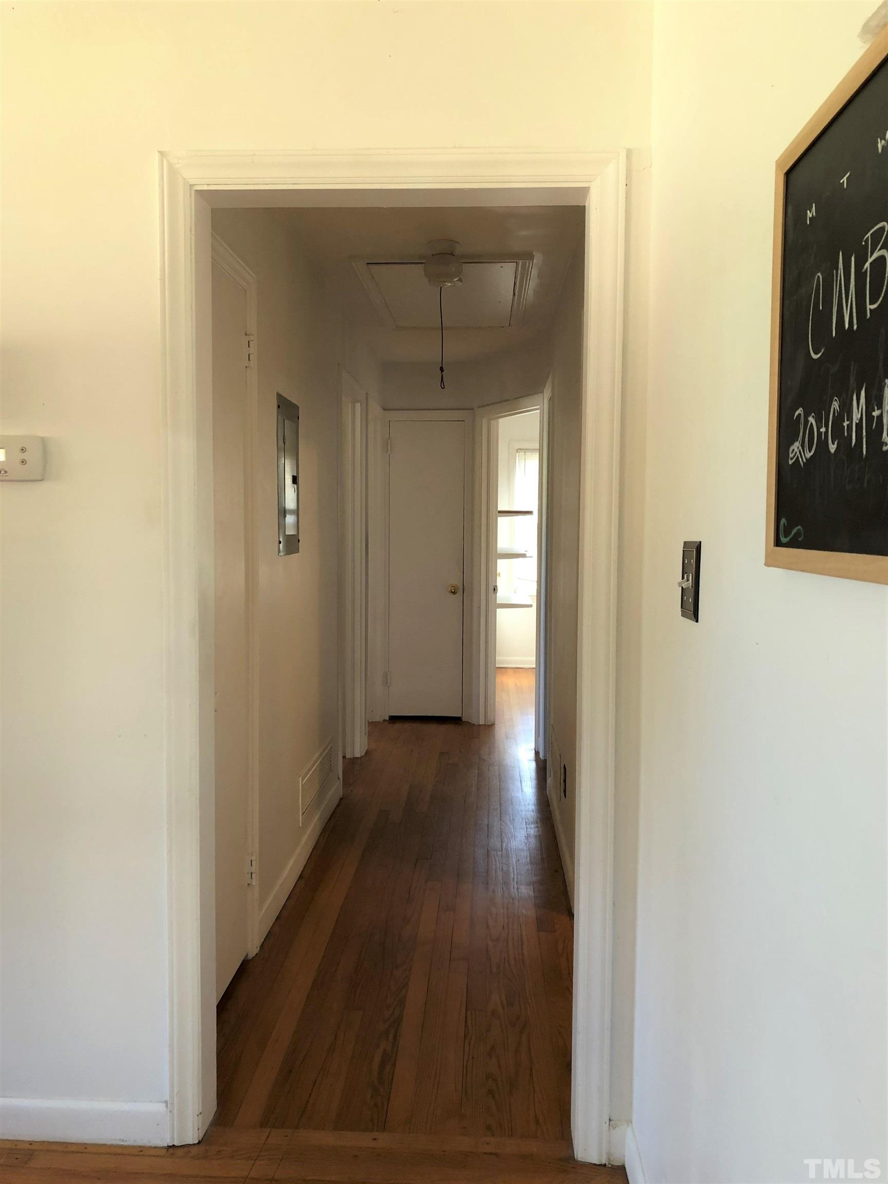 1402 Southerlund Road Garner, NC 27529 - Photo 4 of 18 a view of a hallway with wooden floor