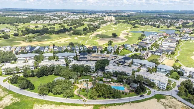 an aerial view of residential houses with outdoor space and swimming pool