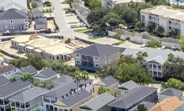 an aerial view of residential houses with outdoor space