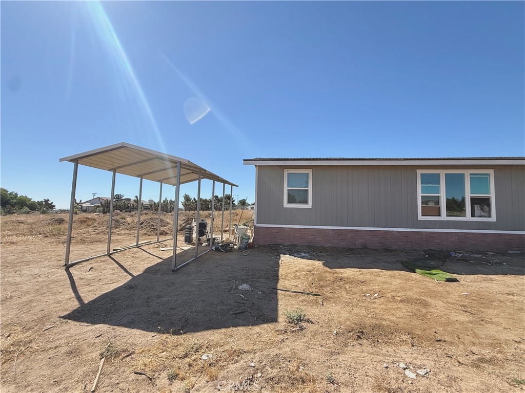 9589 Paramount Road Phelan, CA 92371 - Photo 3 of 29 a view of a house with backyard and sitting area