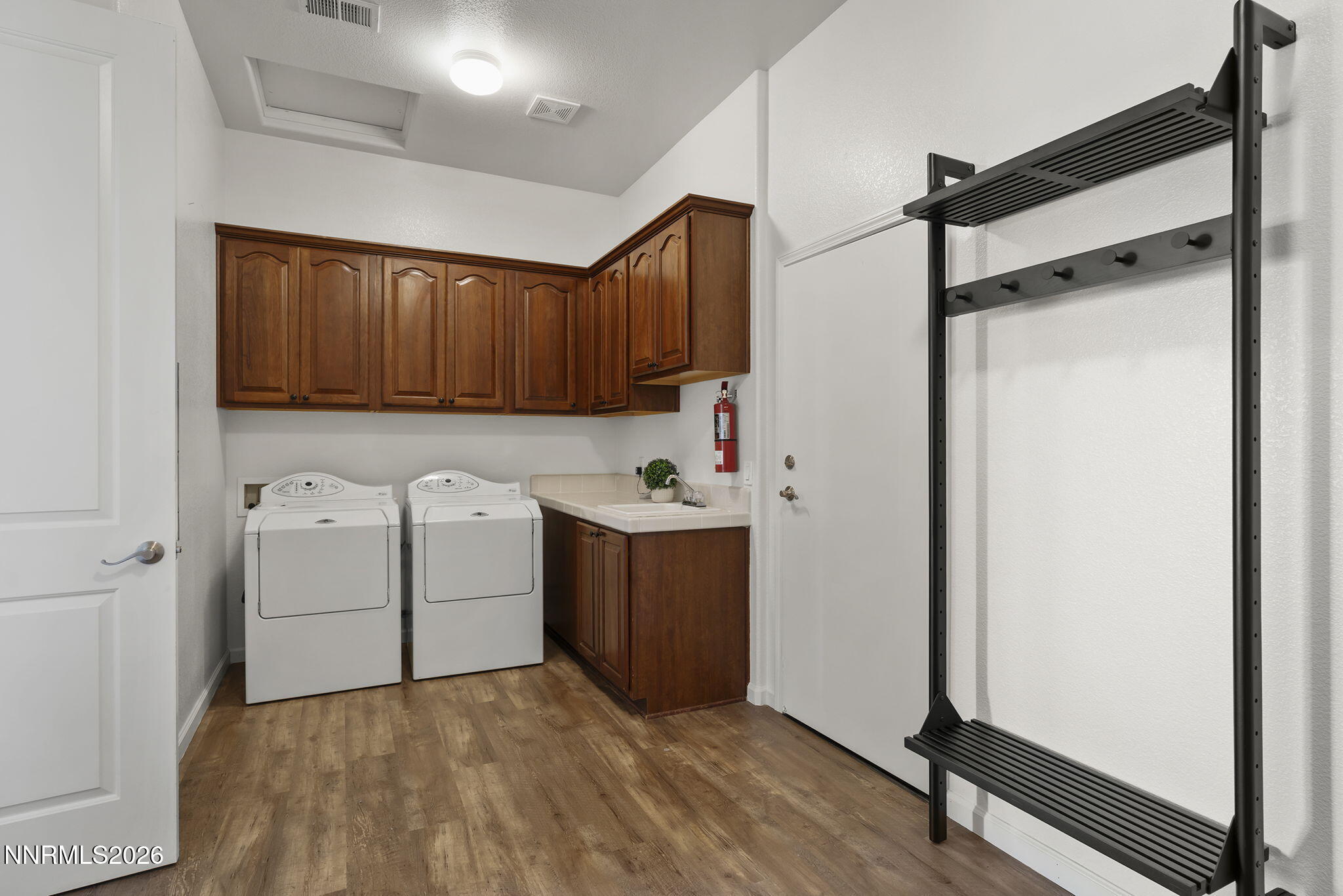 9900 Wilbur May Parkway, Unit 304 Reno, NV 89521 - Photo 27 of 47 a utility room with cabinets washer and dryer