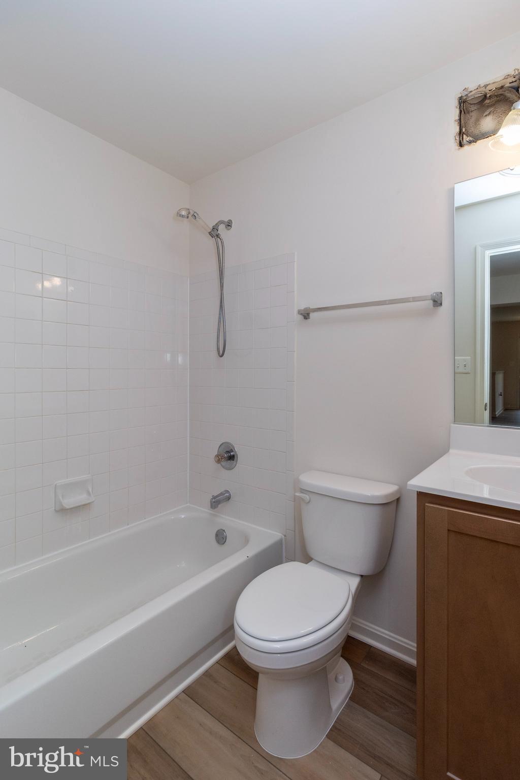 4145 Apple Orchard Court, Unit 1 Suitland, MD 20746 - Photo 15 of 16 a bathroom with a toilet and a bath tub
