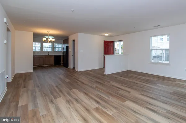 a view of a room with wooden floor and windows
