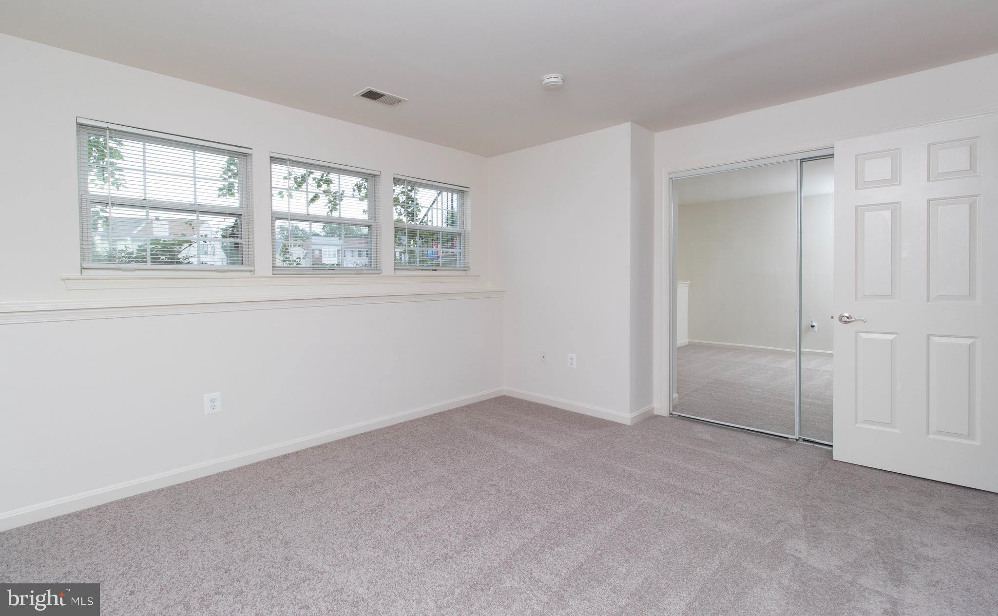 4145 Apple Orchard Court, Unit 1 Suitland, MD 20746 - Photo 9 of 16 an empty room with windows