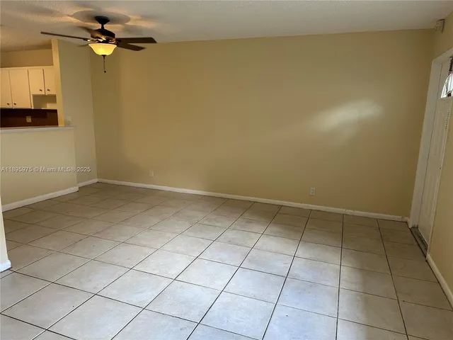 a kitchen with granite countertop white cabinets and black appliances