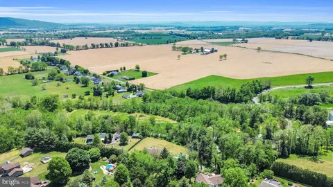 an aerial view of residential houses with outdoor space and river