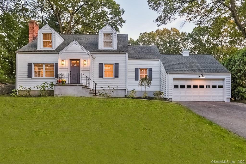 5 Falmouth Road Fairfield, CT 06825 - Photo 1 of 1 a front view of house with yard and trees in the background