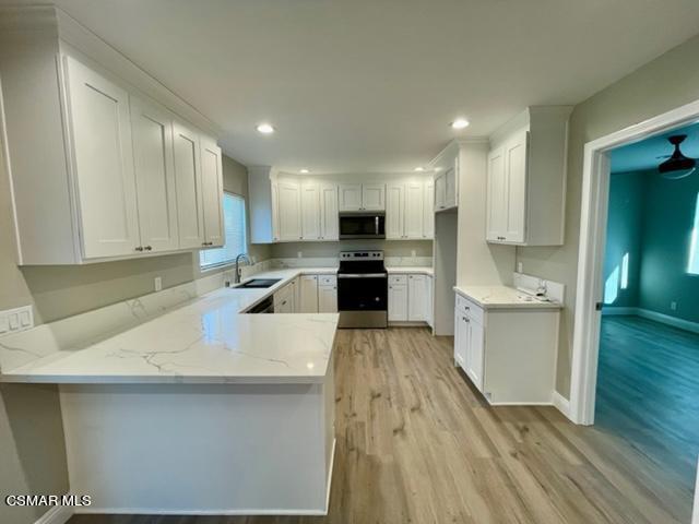 1243 Able Circle Simi Valley, CA 93065 - Photo 2 of 10 a large kitchen with a sink stainless steel appliances and cabinets