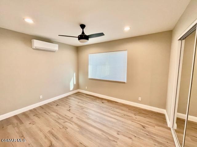 1243 Able Circle Simi Valley, CA 93065 - Photo 7 of 10 a view of an empty room with wooden floor and a ceiling fan