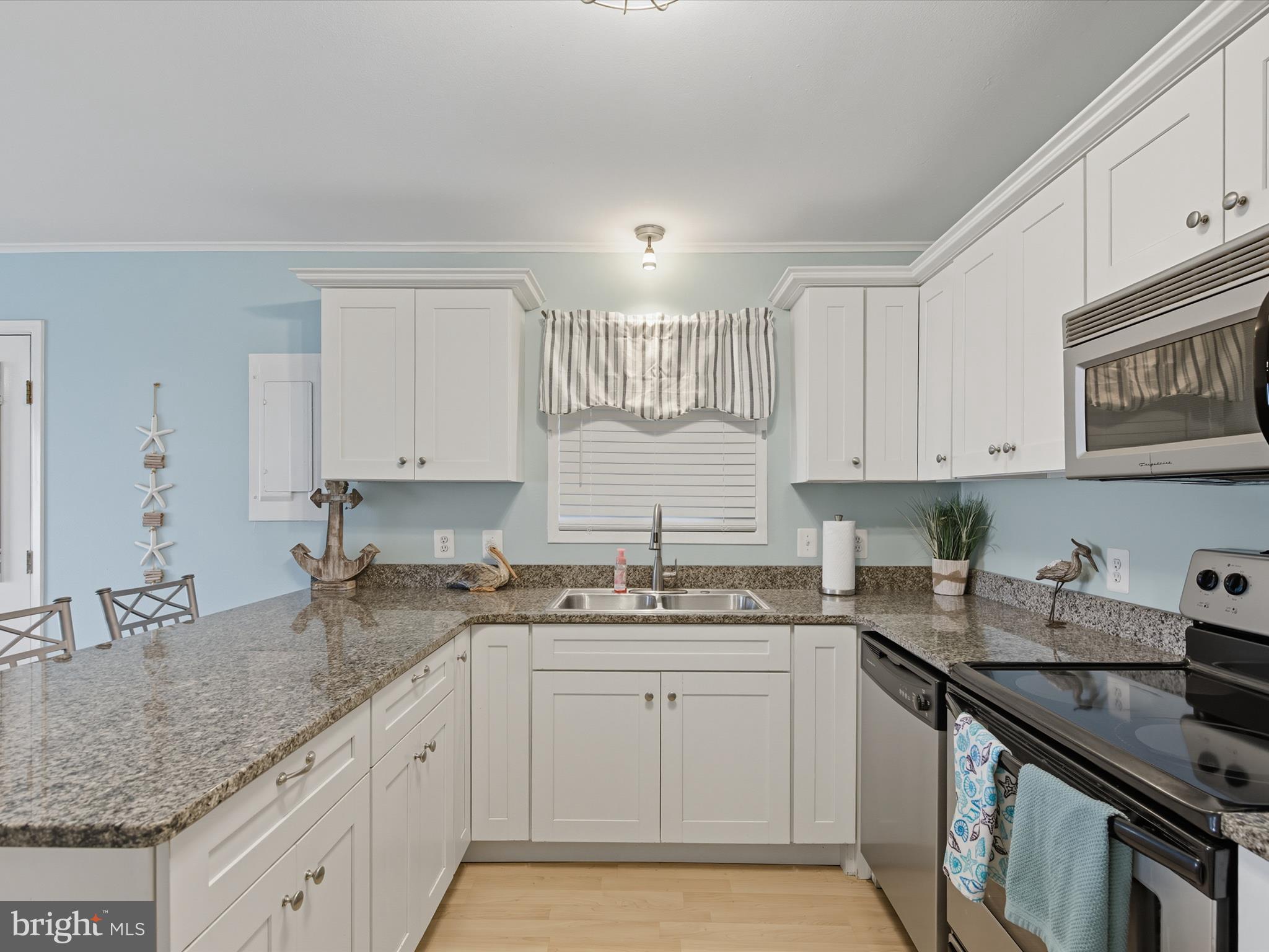 710 Bradley Road, Unit A2 Ocean City, MD 21842 - Photo 11 of 40 a kitchen with a sink stove and cabinets