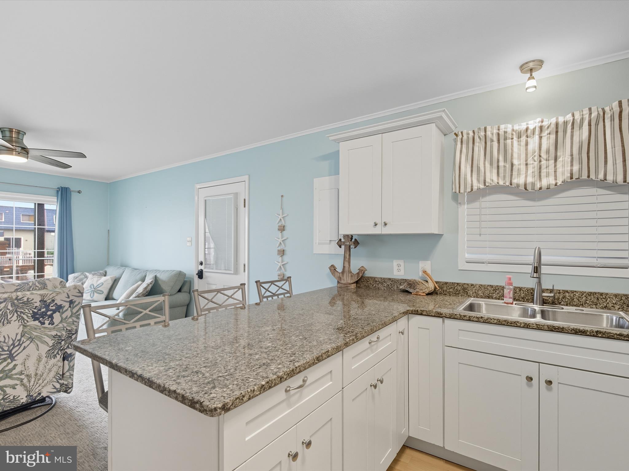 710 Bradley Road, Unit A2 Ocean City, MD 21842 - Photo 12 of 40 a kitchen with granite countertop a sink and cabinets