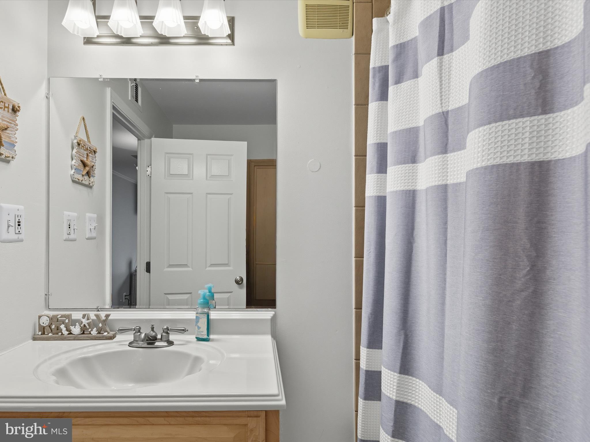 710 Bradley Road, Unit A2 Ocean City, MD 21842 - Photo 14 of 40 a bathroom with a sink and a mirror