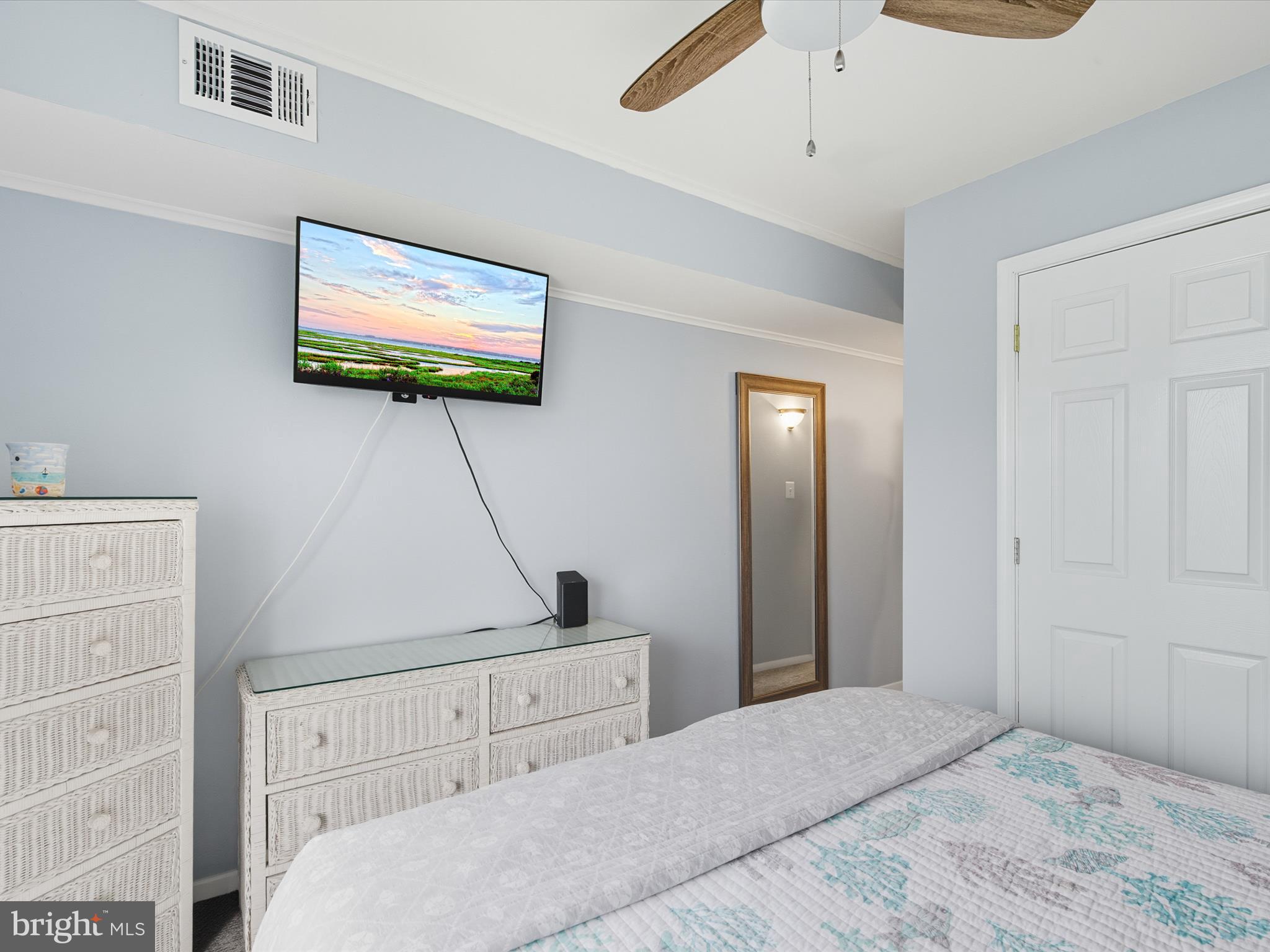 710 Bradley Road, Unit A2 Ocean City, MD 21842 - Photo 16 of 40 a bedroom with a bed and a flat screen tv