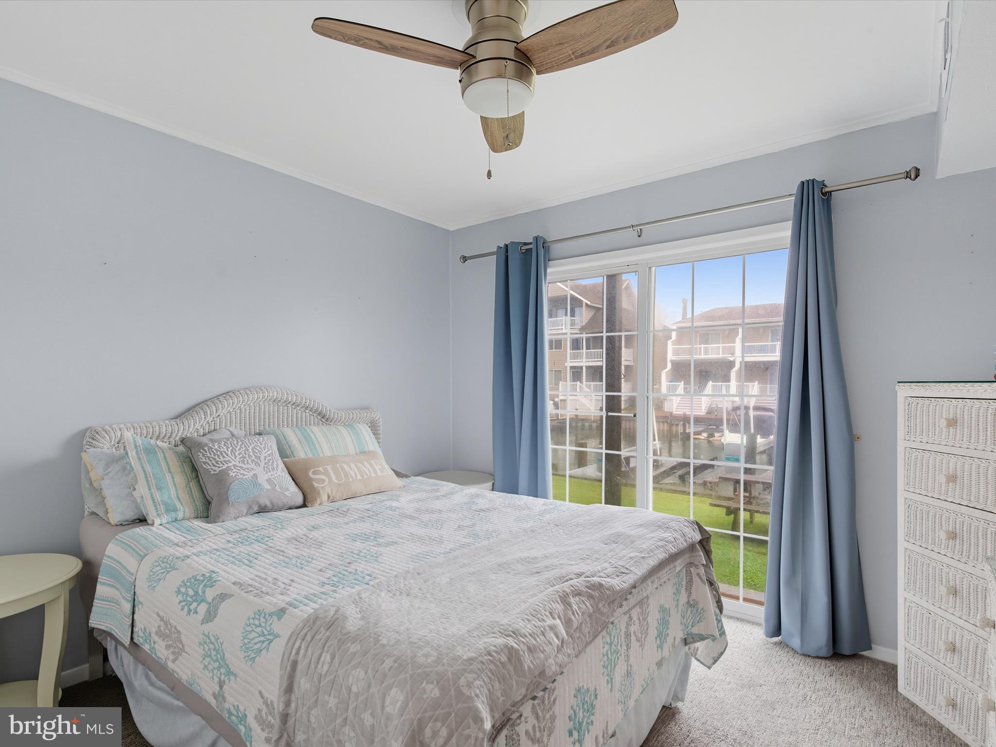 710 Bradley Road, Unit A2 Ocean City, MD 21842 - Photo 17 of 40 a bedroom with a large bed and a chandelier
