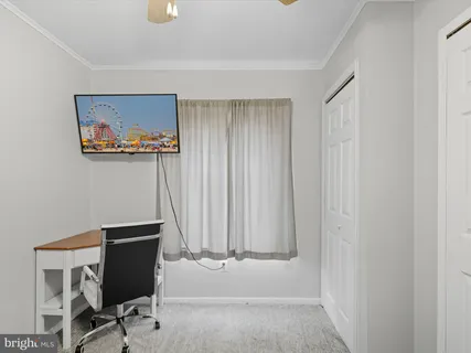 a view of a hallway with workspace and a window