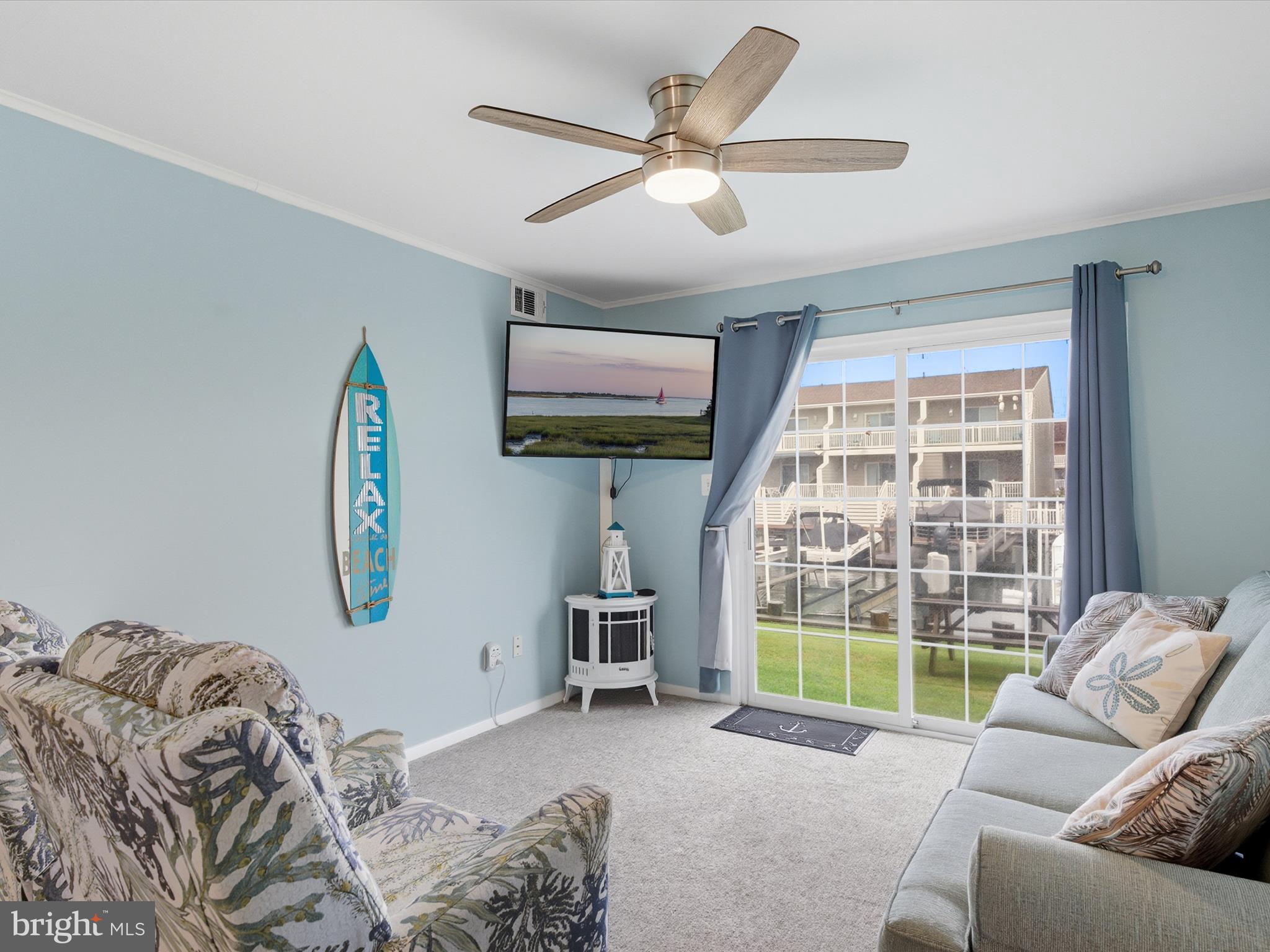 710 Bradley Road, Unit A2 Ocean City, MD 21842 - Photo 2 of 40 a living room with furniture and a large window