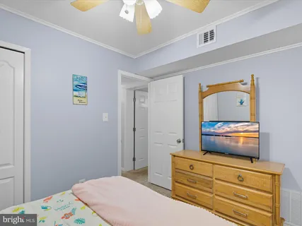 a bedroom with a bed and a dresser