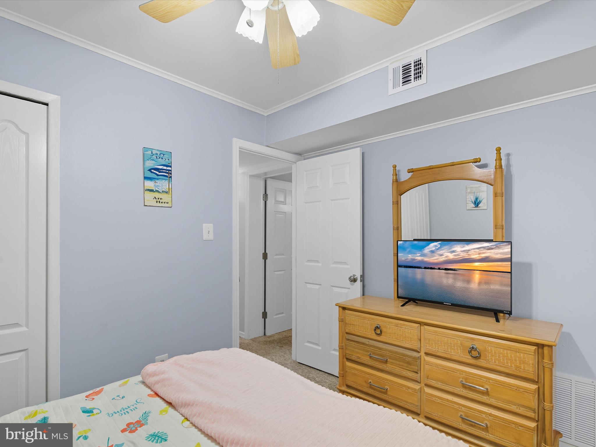 710 Bradley Road, Unit A2 Ocean City, MD 21842 - Photo 22 of 40 a bedroom with a bed and a dresser