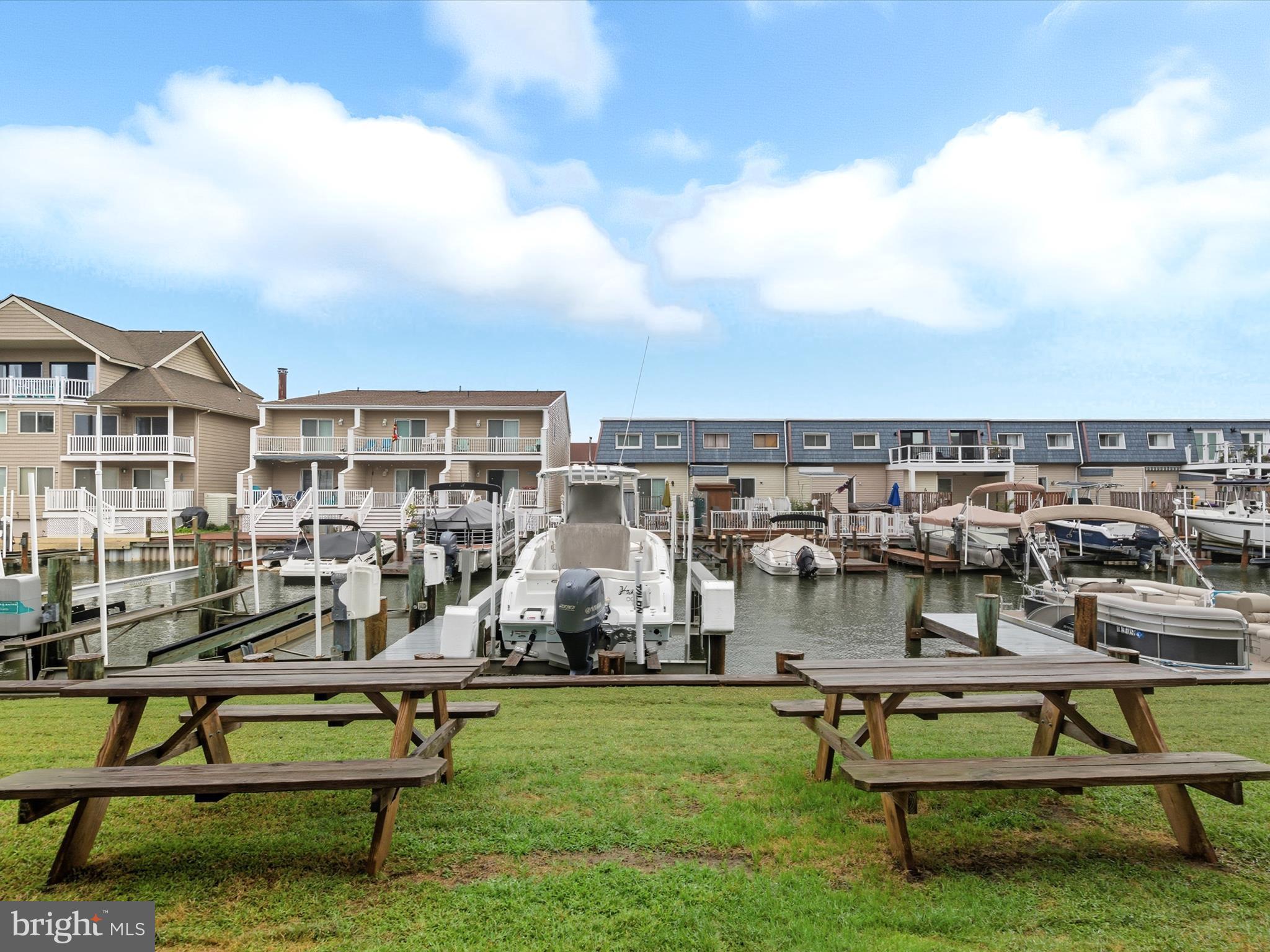 710 Bradley Road, Unit A2 Ocean City, MD 21842 - Photo 27 of 40 a view of a swimming pool with lawn chairs and a yard