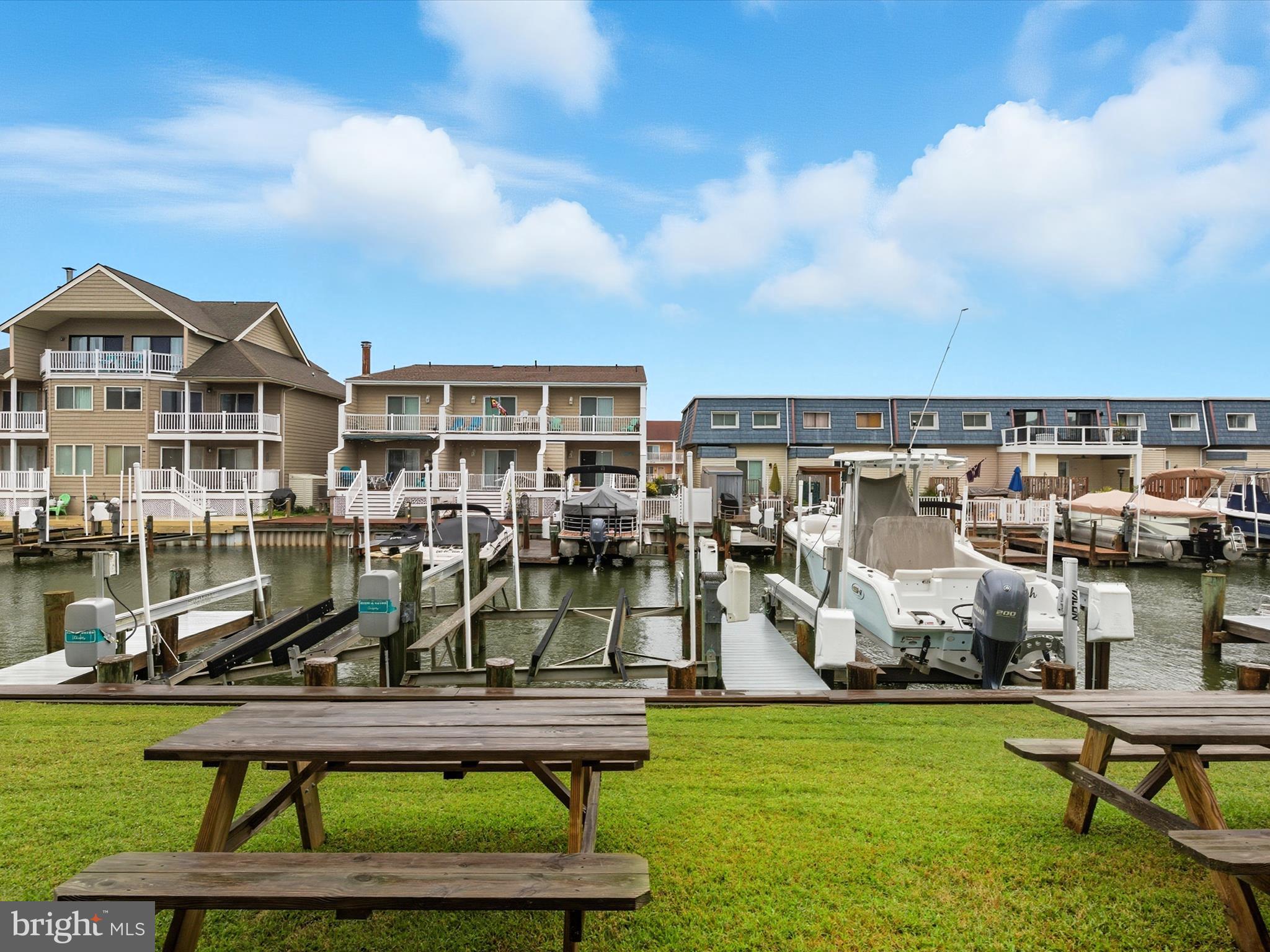 710 Bradley Road, Unit A2 Ocean City, MD 21842 - Photo 30 of 40 a view of a swimming pool with a yard and sitting space