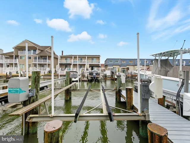 a front view of multiple houses with yard