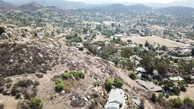 an aerial view of residential houses with city view
