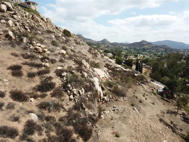 a view of a mountain range with trees in the background