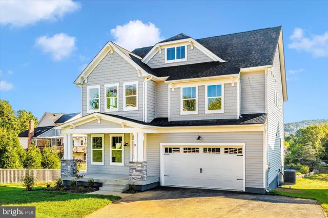 a front view of a house with a yard table and chairs