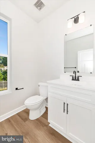 a bathroom with a toilet a sink and a mirror