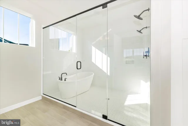 a bathroom with a bathtub and a shower
