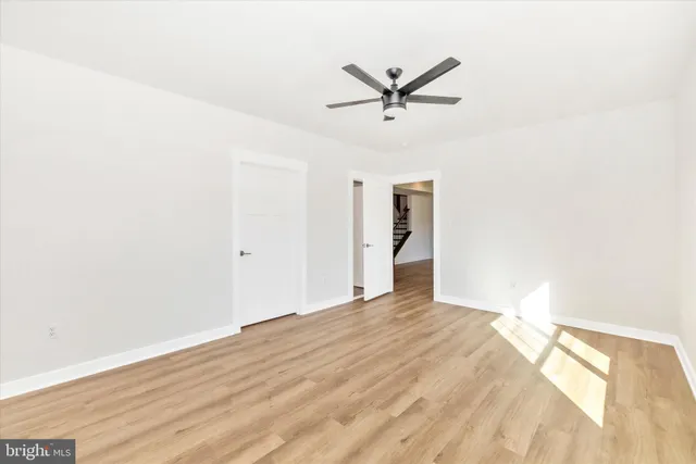 a view of a big room with wooden floor closet and windows