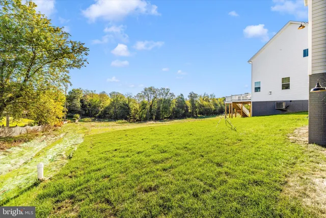 a view of yard with swimming pool and green space