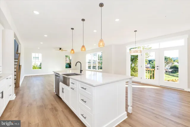 a large bathroom with a large window a sink a center island and a window