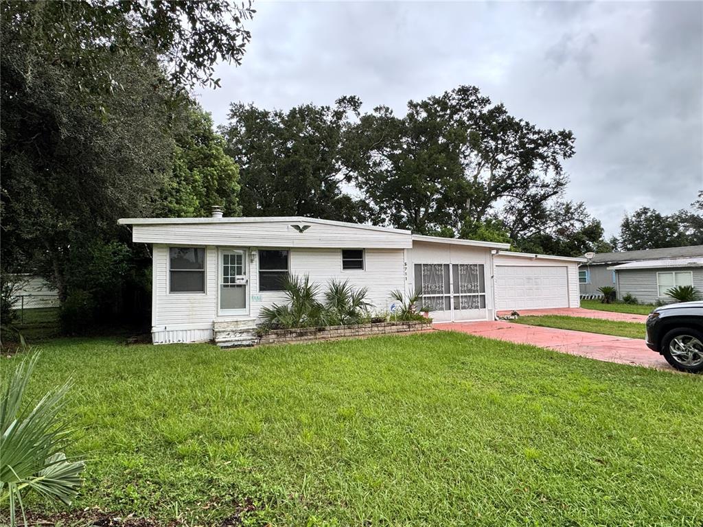 5711 Southwest 63rd Street Ocala, FL 34474 - Photo 1 of 1 a view of a house with a yard and potted plants